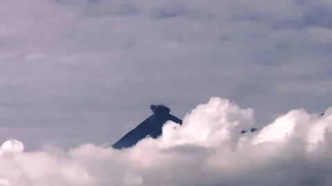 Volcano blows ash above clouds Stock Footage 259849833