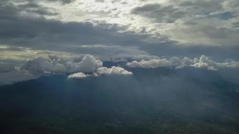 Volcano with cloudy clear sky. Mount Merapi in Indonesia. Cloudy sky with a v 写真素材
