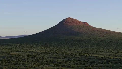 Volcano Cone and Wind Turbines at Dusk Tracking 4K HLG Stock Footage 343802649