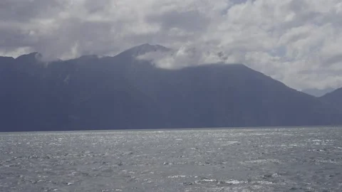 Volcano covered by clouds against blue sky Stock Footage 308578449