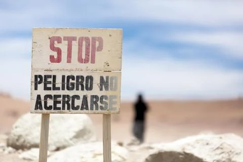 Volcano danger warning sign post in Solar de Manana geyser, Bolivia Stock Photos