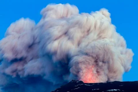 A volcano erupting, with an ash cloud exploding into the air. Stock Photos