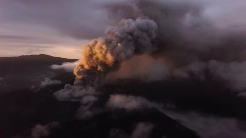 Volcano eruption at dawn, ashes break out of the volcano's vent Stock Footage 125482351
