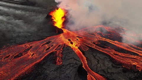 Volcano eruption, red hot burning lava erupts from ground, drone fly over active Stock Footage 252769317