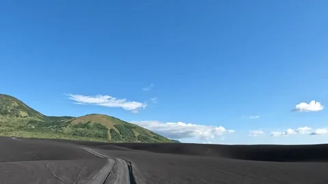 Volcano excursion tour with 4x4, driving through dark black rocks and gravel. Video stock 225633954
