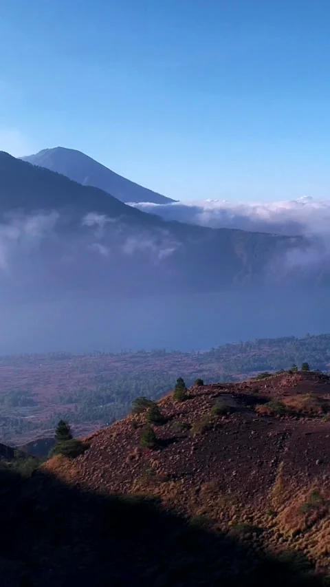 Volcano with lake at the bottom and edge of another with smoke Stock Footage 230290732