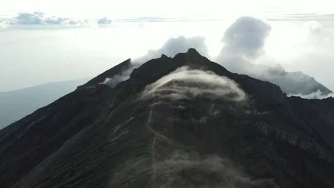 Volcano, mountains, sky with clouds, traces of lava on the ground. Aerial view Stock Footage 237499561