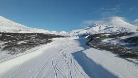 VOLCANO MOUNTAINS WINTER SNOWBIKES AERIAL Stock Footage 150184053