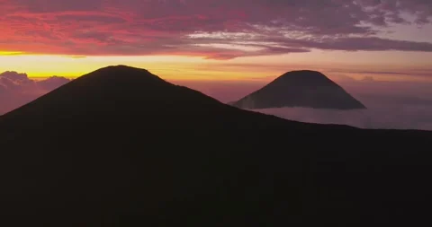 Volcano Peak Emerging Through Sunset Haze in Indonesia Stock Footage 328931484