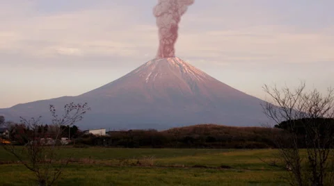Volcano rages with ash and smoke into the sky Stock Footage