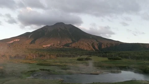 The volcano. The reflected in the thermal spring . Kamchatka Peninsula. Pacific Video stock 232368585