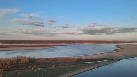 Volga Flight at sunset over the river in the sky with clouds in early spring Video stock 198130381