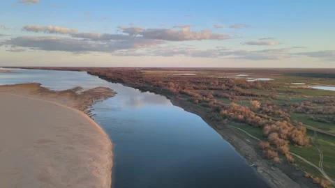 Volga Flight at sunset over the river in the sky with clouds in early spring Video stock 198130446