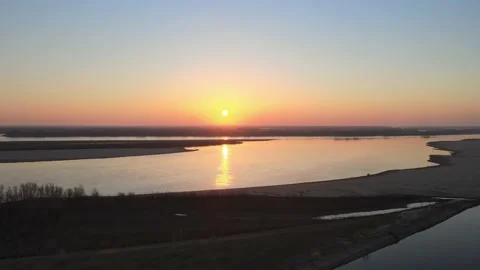 Volga Flight at sunset over the river in the sky with clouds in early spring Video stock 198131402