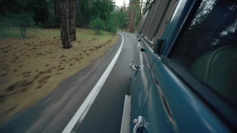 Volkswagon Bus Driving Through a Forest Stock Footage 263008728
