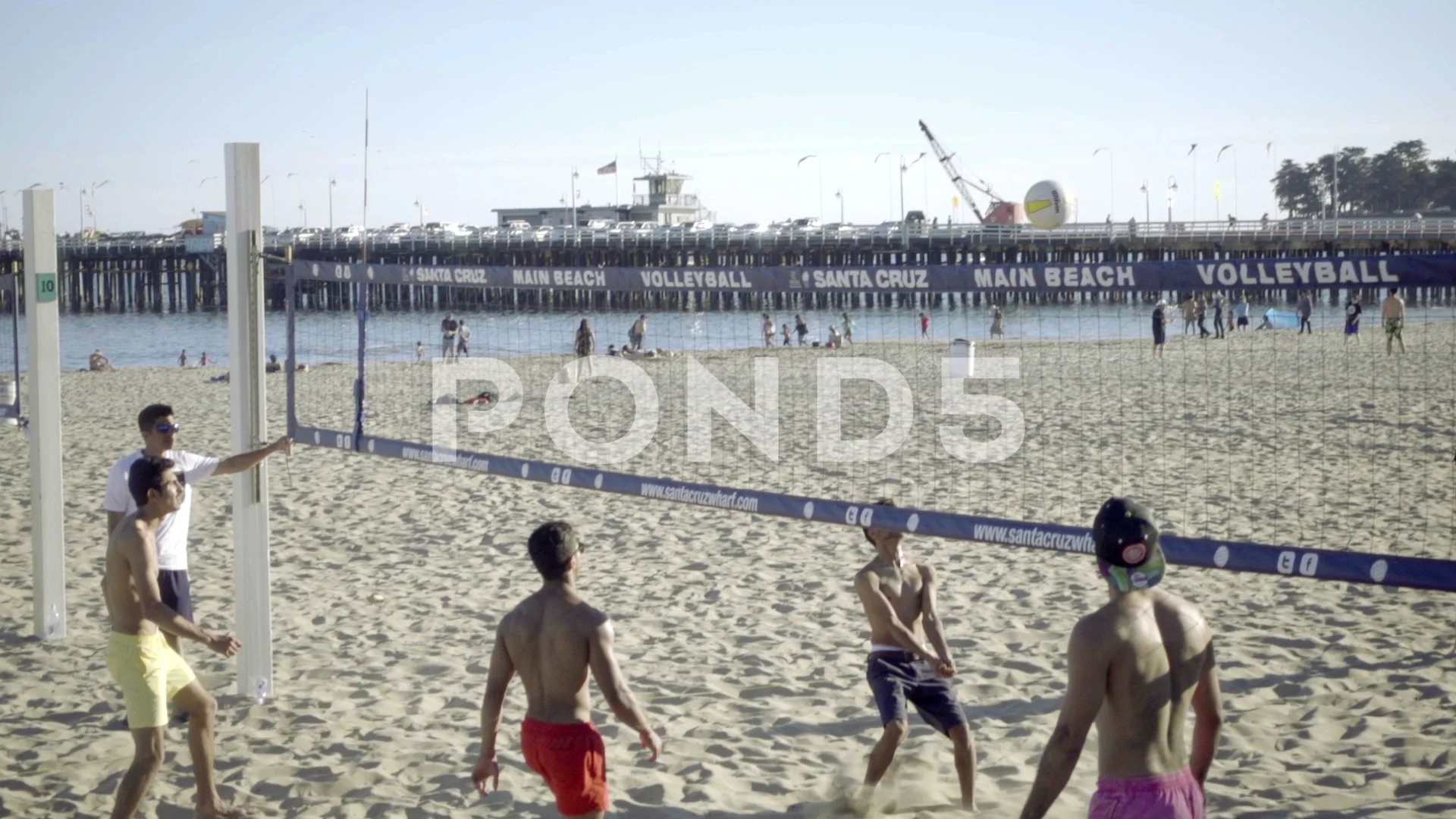 volleyball game with shirtless guys on Santa Cruz Beach in California