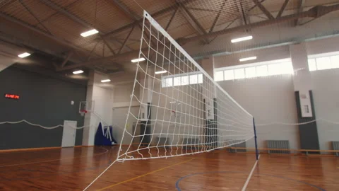 Volleyball net above empty field in sports school gym Stock Footage 217687168