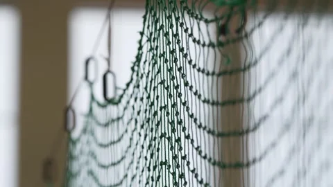 Volleyball net casts intricate shadow pattern across wall Video stock 323840360