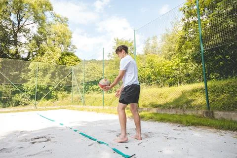 Volleyball player practicing a bump pass on a sand court, focusing on techniq Foto stock