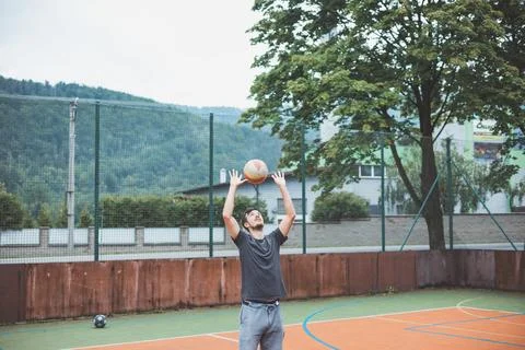 Volleyball player practicing setting the ball on a hard court, focusing on co Foto stock
