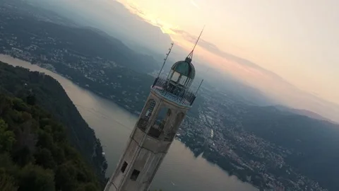 Volta Lighthouse Brunate overlooking Lake Como at sunset. aerial, pullback shot Video stock 333920128