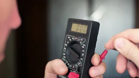 Voltage measurement of a source of electric energy with multimeter ohmmeter Video stock 133741809