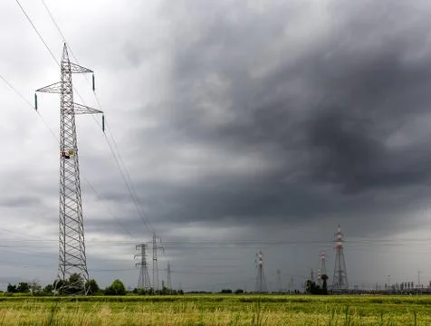 Voltage pylons during a thunderstorm Stock Photos