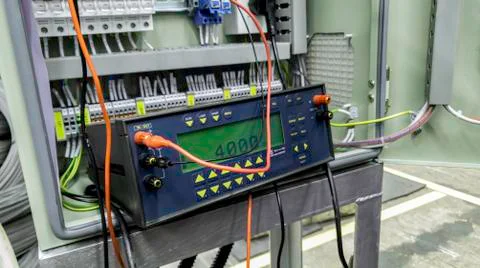 Voltage source calibrator device with control panel in factory site, Current  Stock Photos
