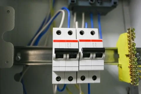 Voltage switchboard 220 volt, electrical cables with  modern circuit breakers ar Stock Photos