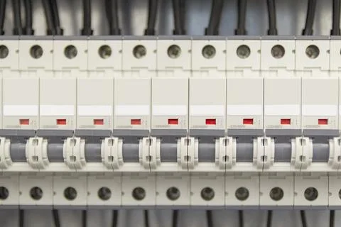 Voltage switchboard with circuit breakers.Wires and cables are connected to e Stock Photos