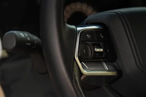 Volume and audio control buttons on the steering wheel. Car audio controls Stock Photos