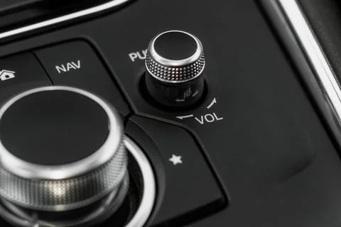 Volume control of car audio system. FM radio button in car panel. Stock Photos