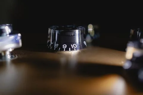 Volume control of an electric guitar in shadow light Stock Photos