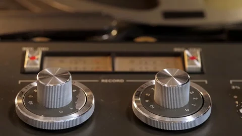 Volume control knobs with spinning reels in background 스톡 동영상 319890859
