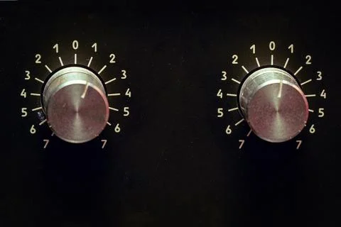 Volume knobs of old amp on black background Fotos de archivo