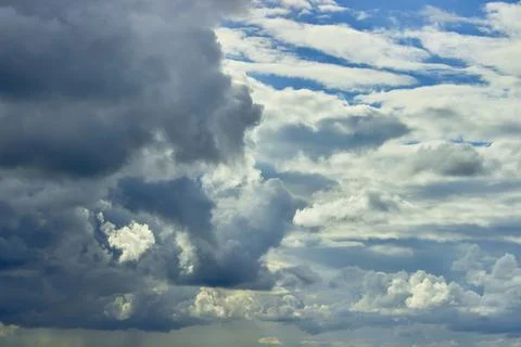 Volumetric blue sky with dramatic clouds. Textured background Stock Photos