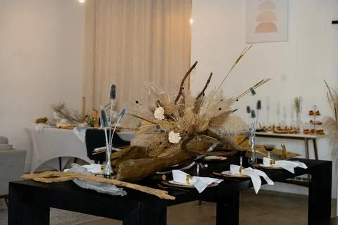 Volumetric table decor with dry branches, reeds and wooden elements Stock Photos