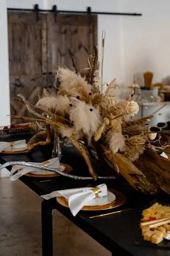 Volumetric table decor with dry branches, reeds and wooden elements Stock Photos