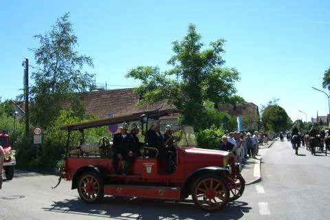 Voluntary fire brigade sitting in oldtimer fire truck 库存照片