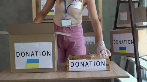 Volunteer center to help victims of the attack on Ukraine. female hands open a Stock Footage 200930909