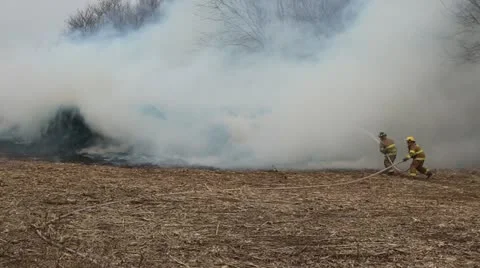 Volunteer Firemen battle blaze Stock Footage