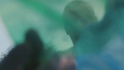 A volunteer guy picking up plastic garbage off green areas Stock Footage 157027912