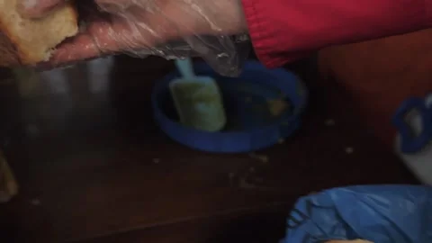 Volunteer hands bread to a hungry elderly man Stock Footage 132564508