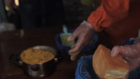 Volunteer hands bread to a hungry elderly man Stock Footage 132564560