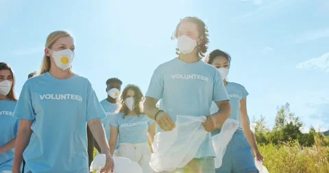 Volunteer leader instructing, high five and cheering up team before work. Group Stock Footage 136613712
