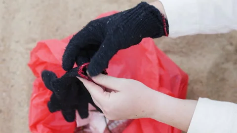 Volunteer puts on fabric gloves. Stock Footage 308446830