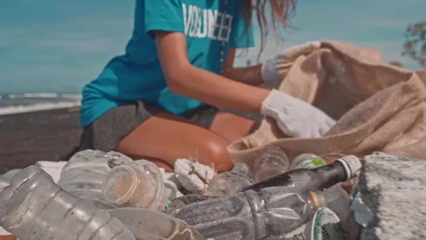 Volunteer sorting plastic litter in eco bag put effort into making planet better Stock Footage 125245973