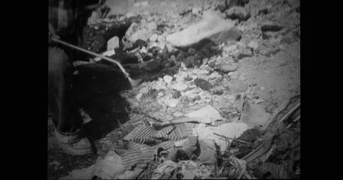 Volunteer spraying insecticides over debris outside shop Stock Footage
