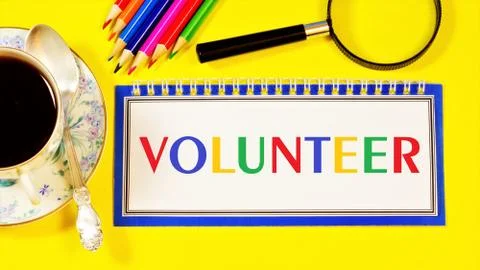 Volunteer  the text label for the notebook planning the event. Stock Photos