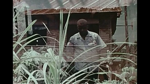 Volunteer visits and explains about family planning programme to villagers-1974 Video stock 95198541